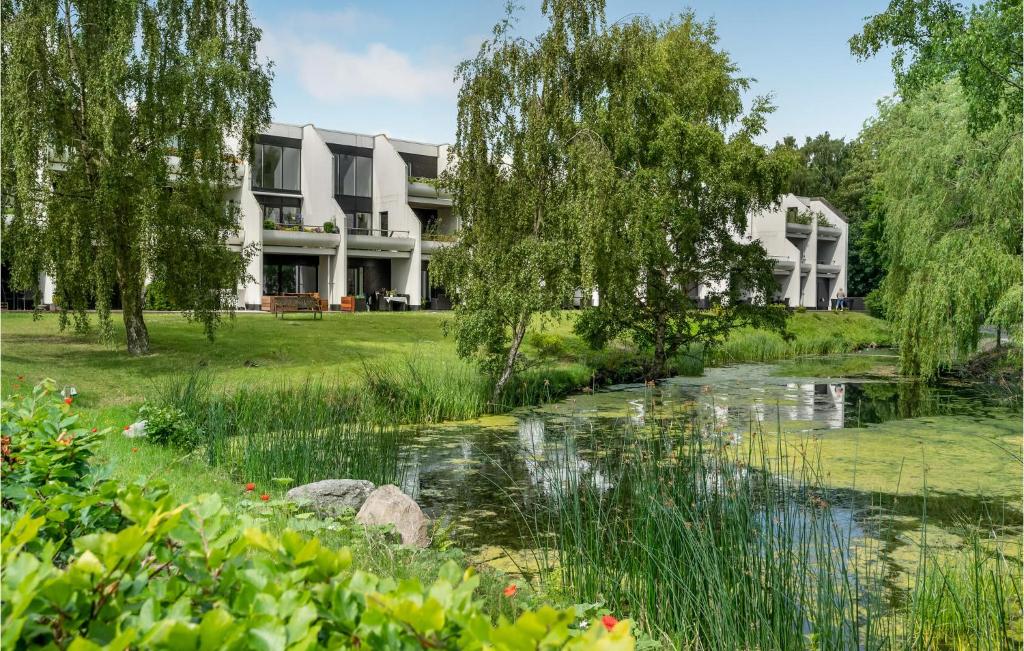 a building with a pond in front of it at Beautiful Apartment In Helsingr With Wifi in Helsingør