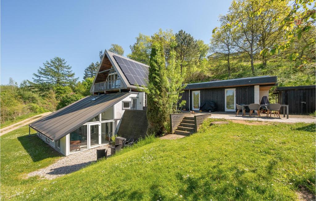 a small house with a gambrel roof on a yard at Gorgeous Home In Ebeltoft With House A Panoramic View in Ebeltoft