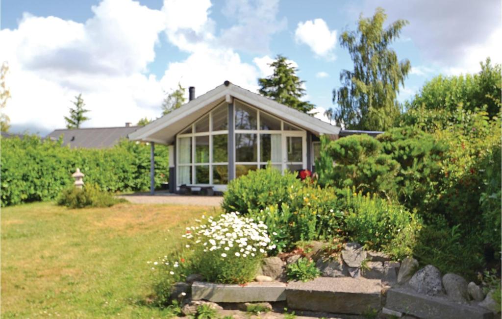 a house with a garden in front of it at Stunning Home In Silkeborg With 2 Bedrooms And Wifi in Silkeborg