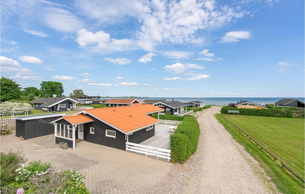 a house with an orange roof and a driveway at Three-Bedroom Holiday Home In Bjert in Binderup Strand
