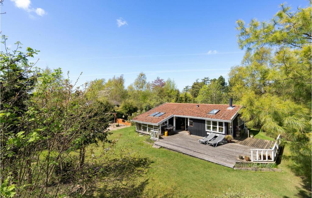 a house with a large deck in the yard at Beautiful Home In Væggerløse With Wifi in Marielyst