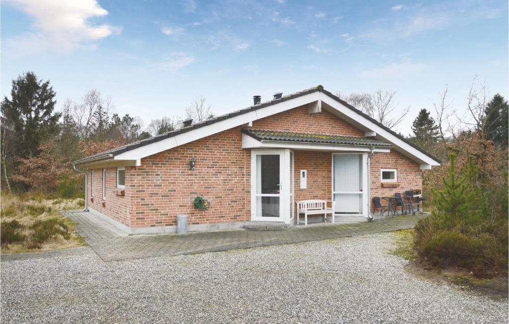 a brick house with a white door and a porch at 3 Bedroom Stunning Home In Herning in Herning