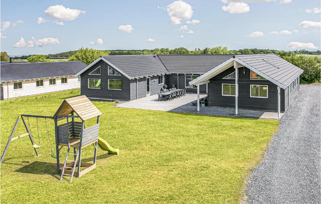 a home with a playground and a house at Nice Home In Bogense With Sauna in Skåstrup