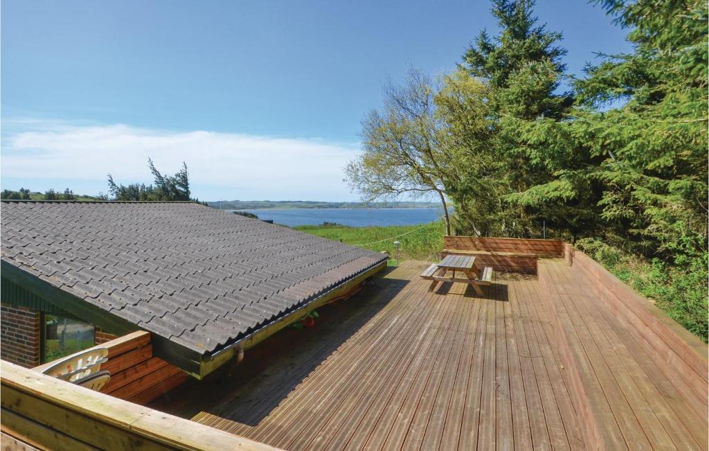 a wooden deck with a bench on top of a house at Awesome Home In Struer With Kitchen in Struer