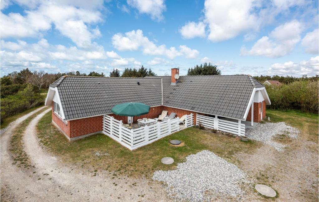 an aerial view of a house with an umbrella at Beautiful Home In Ringkbing With 5 Bedrooms, Sauna And Indoor Swimming Pool in Søndervig