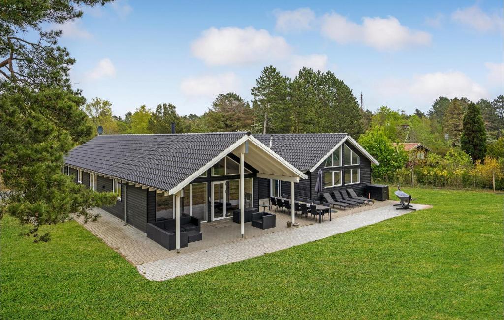 a house with a black roof on a yard at Cozy Home In Vig With Kitchen in Vig