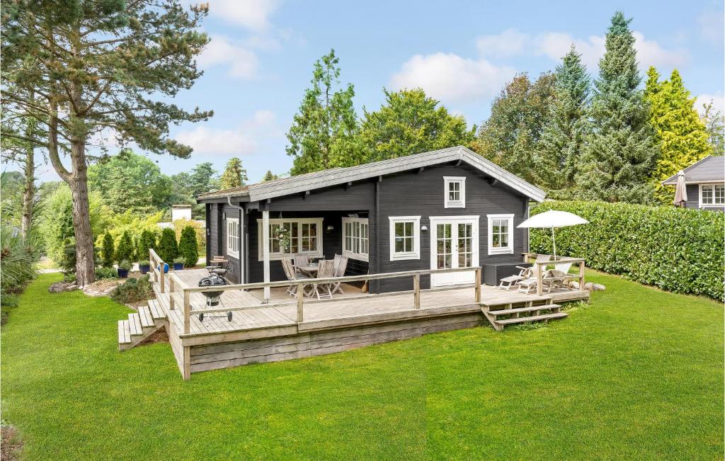 a black tiny house with a large deck at Beautiful Home In Hornbk With Wifi in Hornbæk