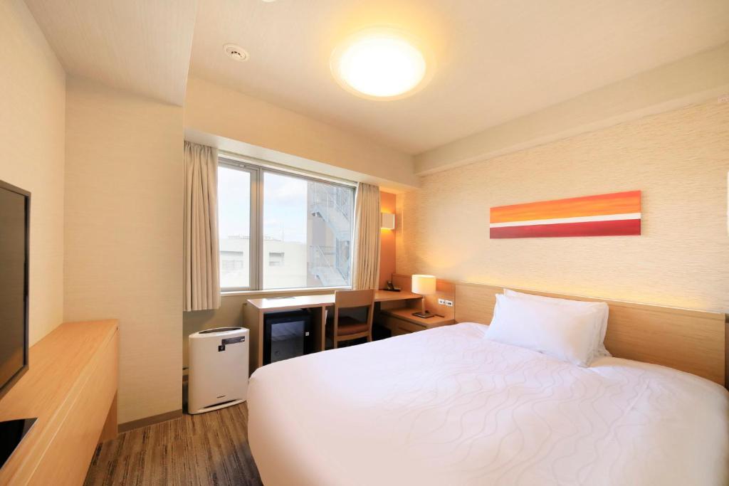 Postel nebo postele na pokoji v ubytování Richmond Hotel Nagoya Shinkansen-guchi