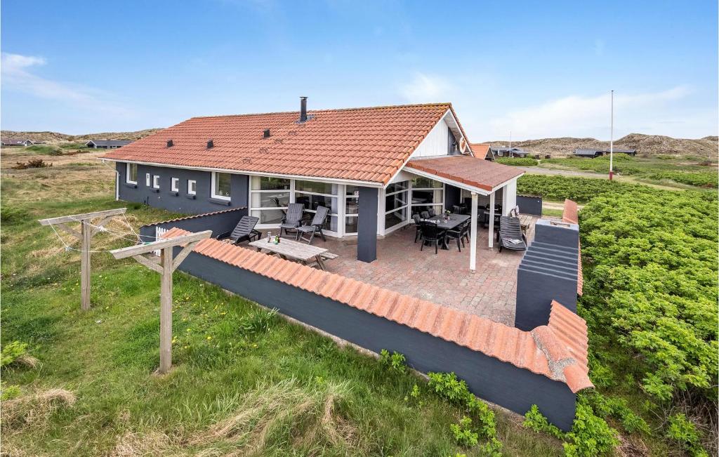 an aerial view of a house with a roof at 4 Bedroom Beautiful Home In Hvide Sande in Hvide Sande