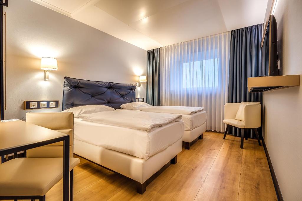 Postel nebo postele na pokoji v ubytování Congress Hotel Chemnitz