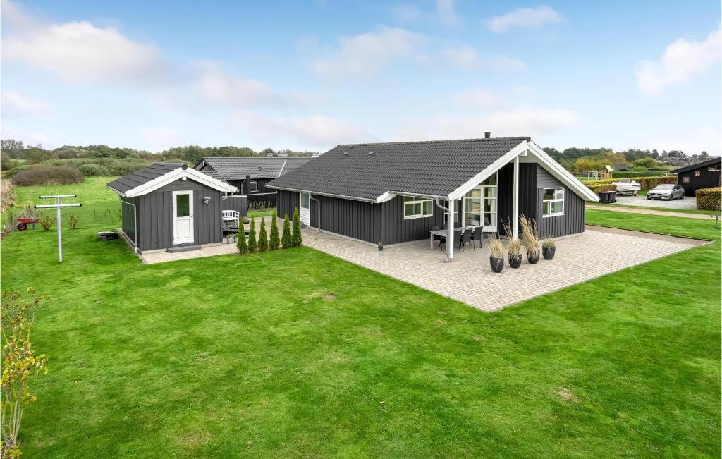 a modular home with a green lawn at Nice Home In Haderslev With 3 Bedrooms, Sauna And Wifi in Råde