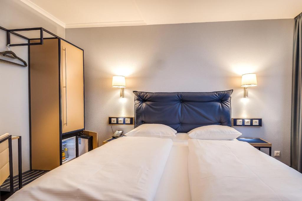 Postel nebo postele na pokoji v ubytování Congress Hotel Chemnitz