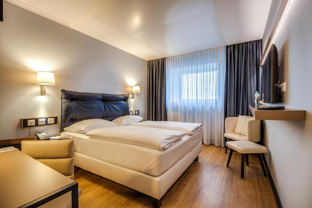 Postel nebo postele na pokoji v ubytování Congress Hotel Chemnitz