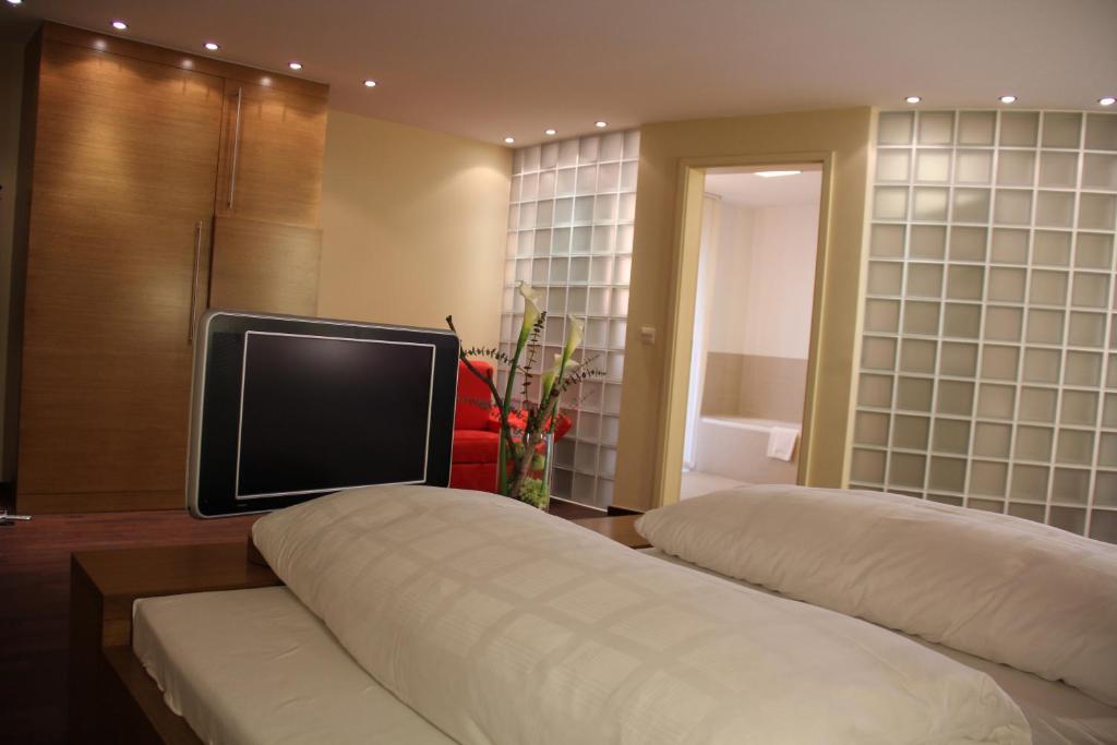 a room with two beds with a tv on top at Hotel Restaurant Schwan in Wertheim