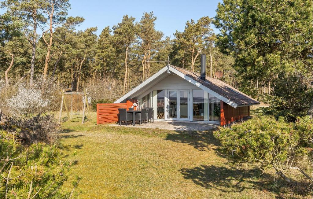 a small house in the middle of a yard at 2 Bedroom Cozy Home In Havndal in Sødring