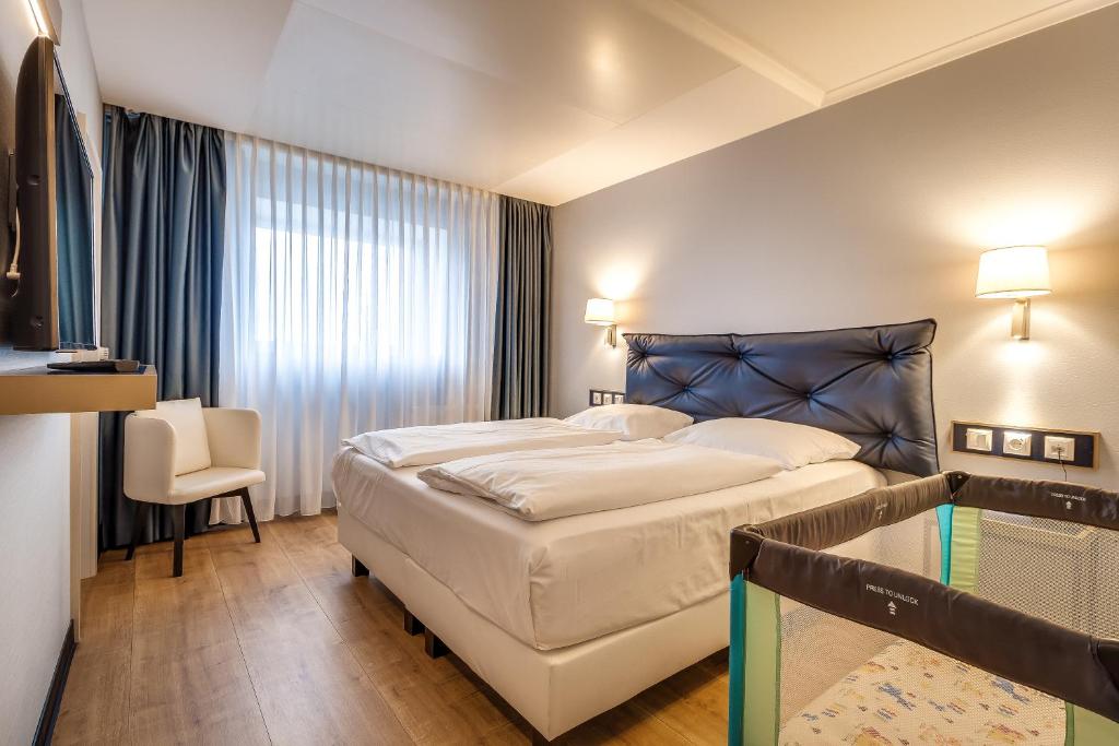 Postel nebo postele na pokoji v ubytování Congress Hotel Chemnitz