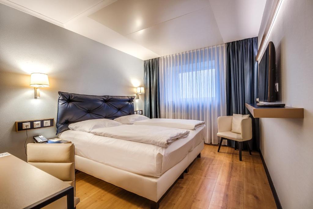 Postel nebo postele na pokoji v ubytování Congress Hotel Chemnitz