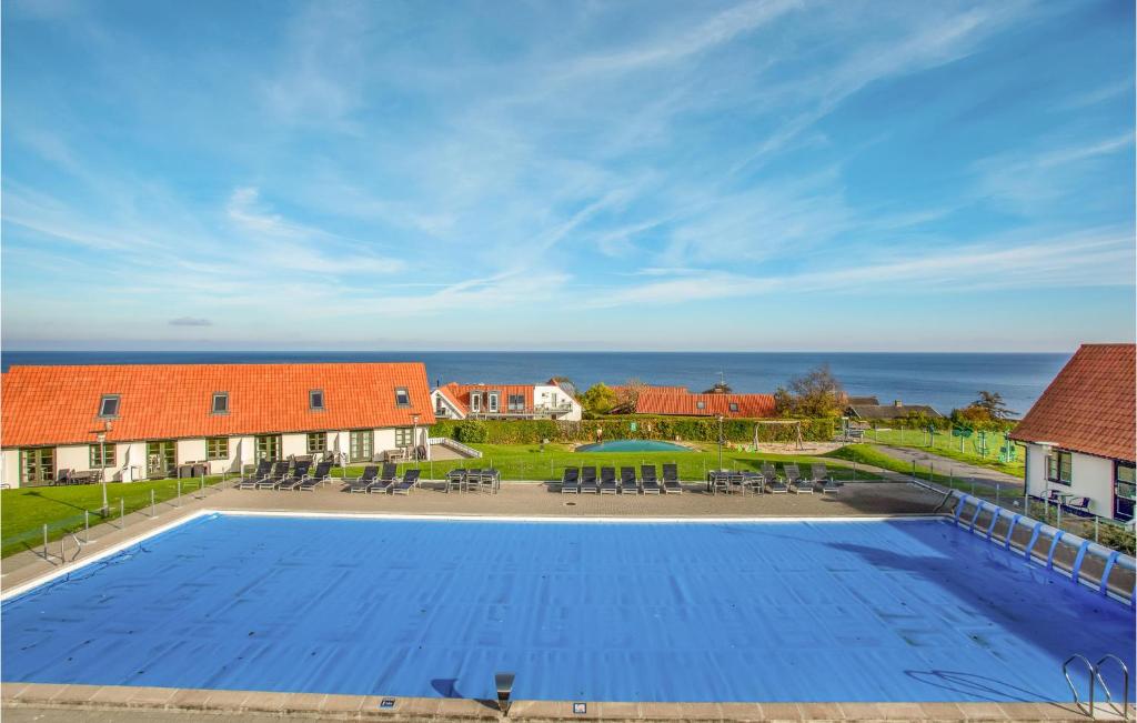 a large swimming pool with a view of the ocean at Lovely Apartment In Gudhjem With Wifi in Gudhjem