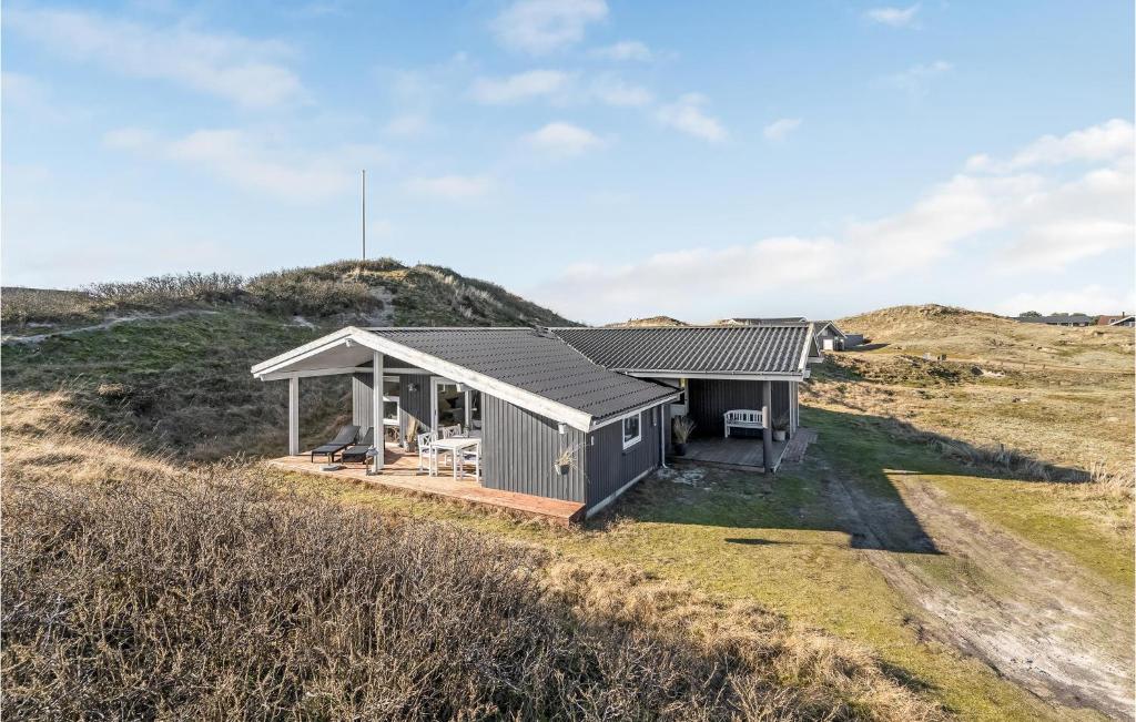 a house on top of a hill at Stunning Home In Fan With House A Panoramic View in Fanø