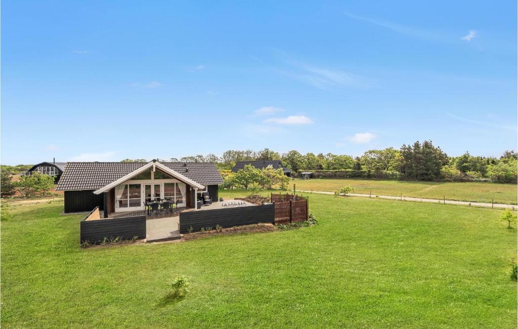 a home with a large yard with a house at Amazing Home In Skjern With Kitchen in Halby