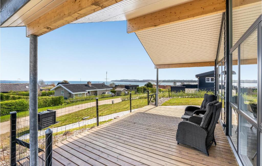 a deck with a view of the ocean from a house at Beautiful Home In Hejls With Wifi in Hejls