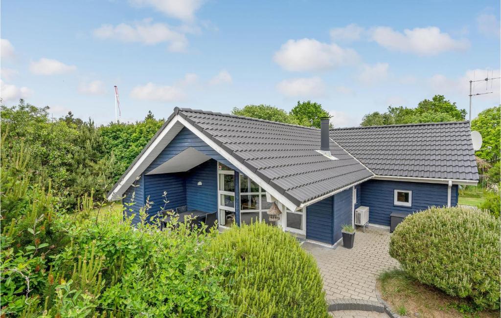 a blue house with a grey roof at Holiday Home Flyndervej Tarm I in Hemmet