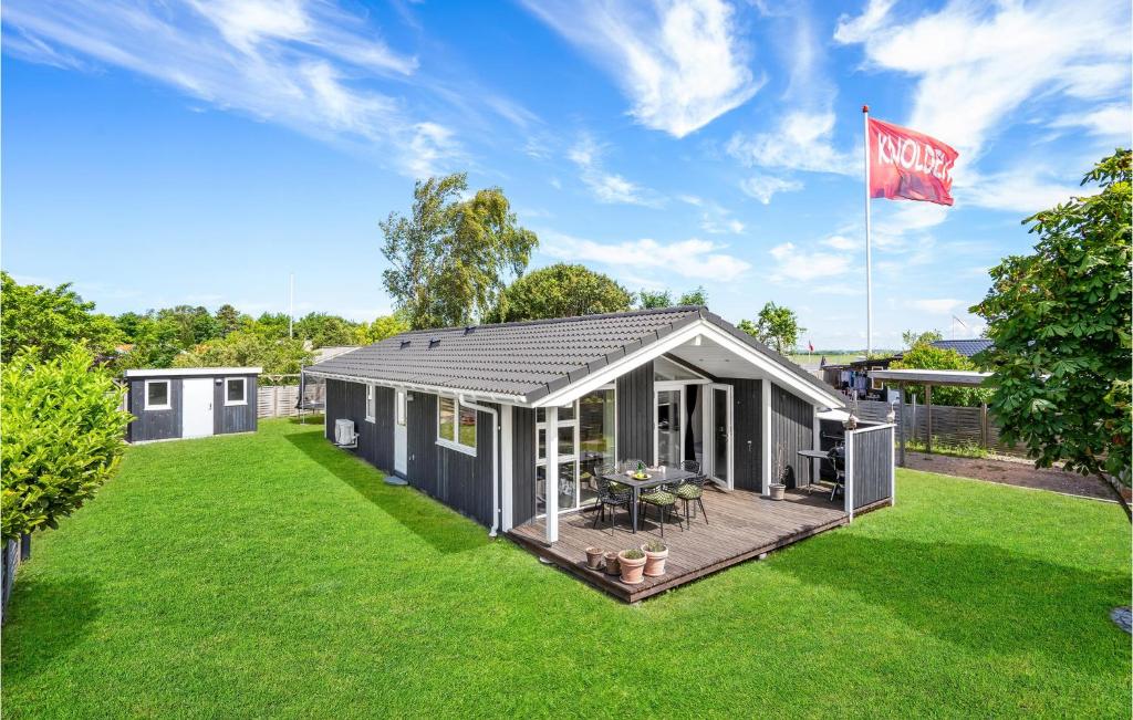 a modular home on a lawn with a flag at Lovely Home In Slagelse With Kitchen in Slagelse