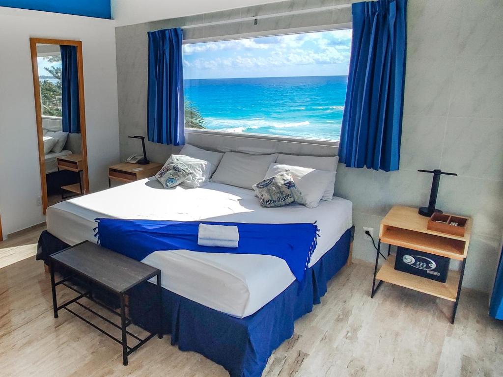 a bedroom with a bed with a view of the ocean at Paradise Beachfront & Nightlife Heart in Cancún