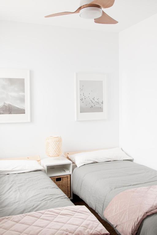 A bed or beds in a room at Felipe Antón Suites