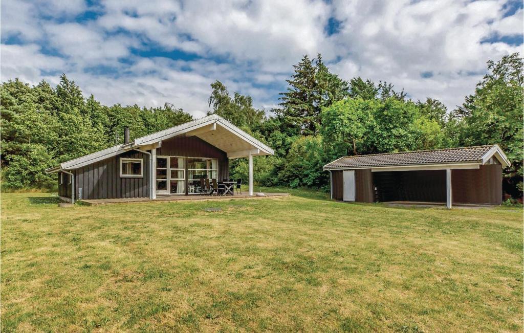a small cabin in a field with a grass yard at Holiday Home Sandleddet Højby Ii in Lumsås