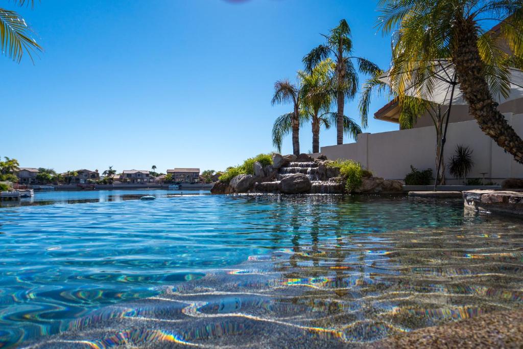 einen Pool mit Palmen in einem Resort in der Unterkunft Santorini in Glendale