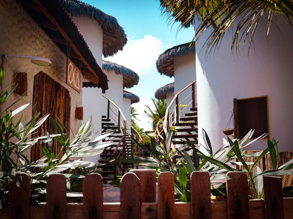 a wooden fence in front of a house at Oka Pousada Atins in Atins