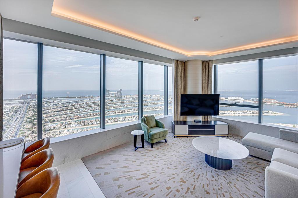 a living room with a view of a city at The Palm Tower, Nakheel Mall, Palm Jumeirah in Dubai