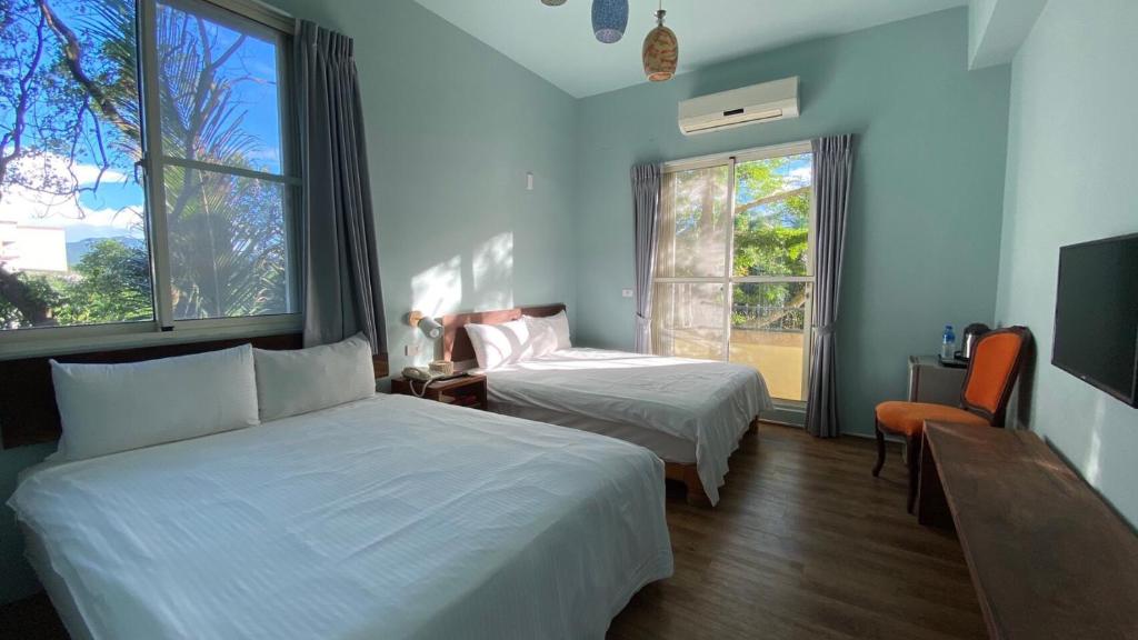 a hotel room with two beds and a window at Cloud Sun Homestay in Zhixue