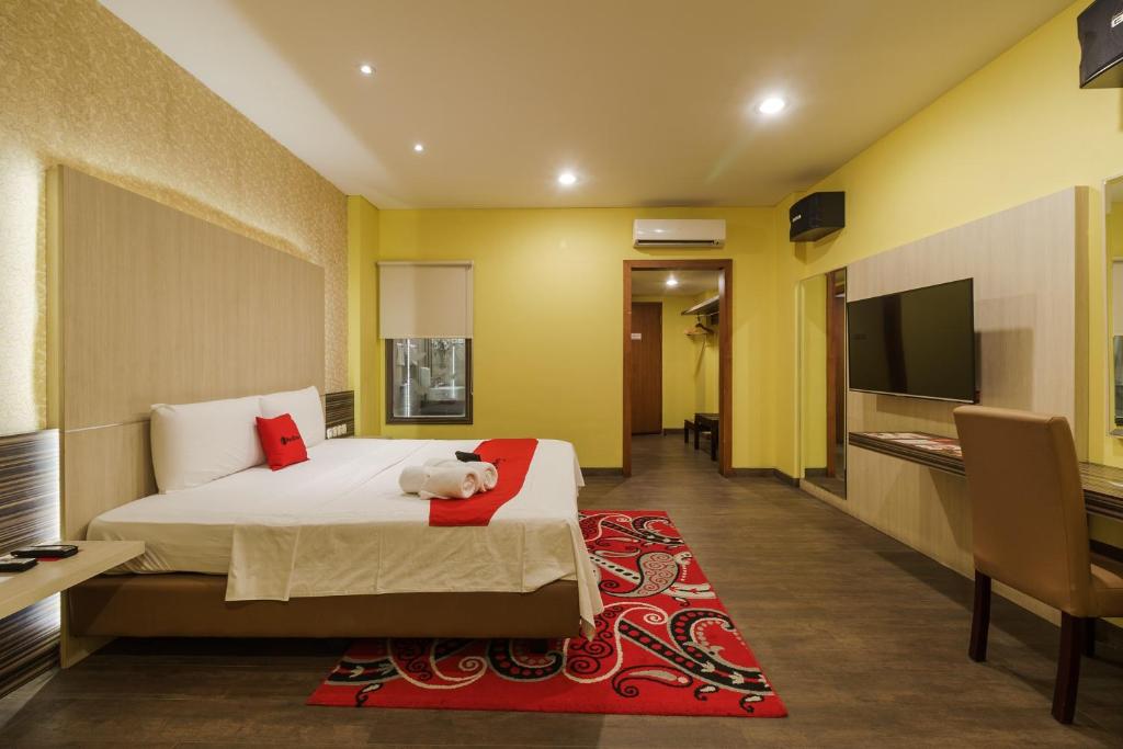 a hotel room with a bed with a teddy bear on it at RedDoorz Plus near Dunia Fantasi Ancol in Jakarta