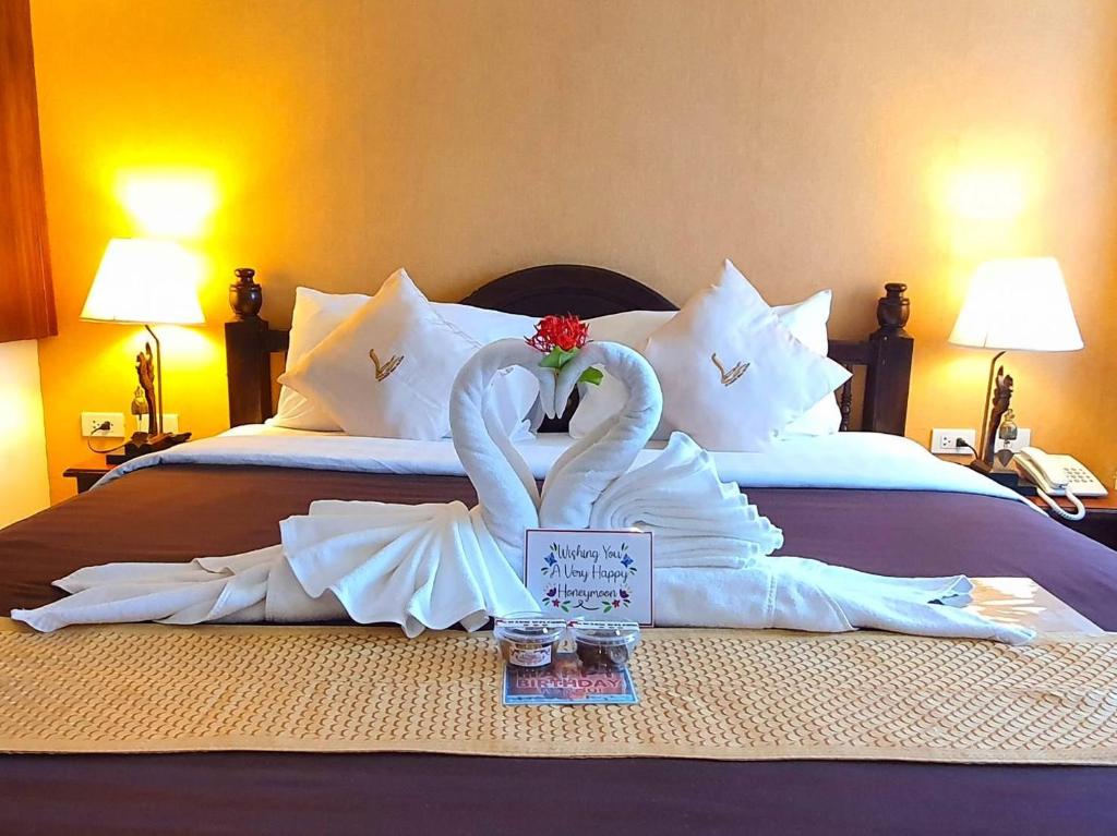 Postel nebo postele na pokoji v ubytování Goldenbell Hotel Chiangmai