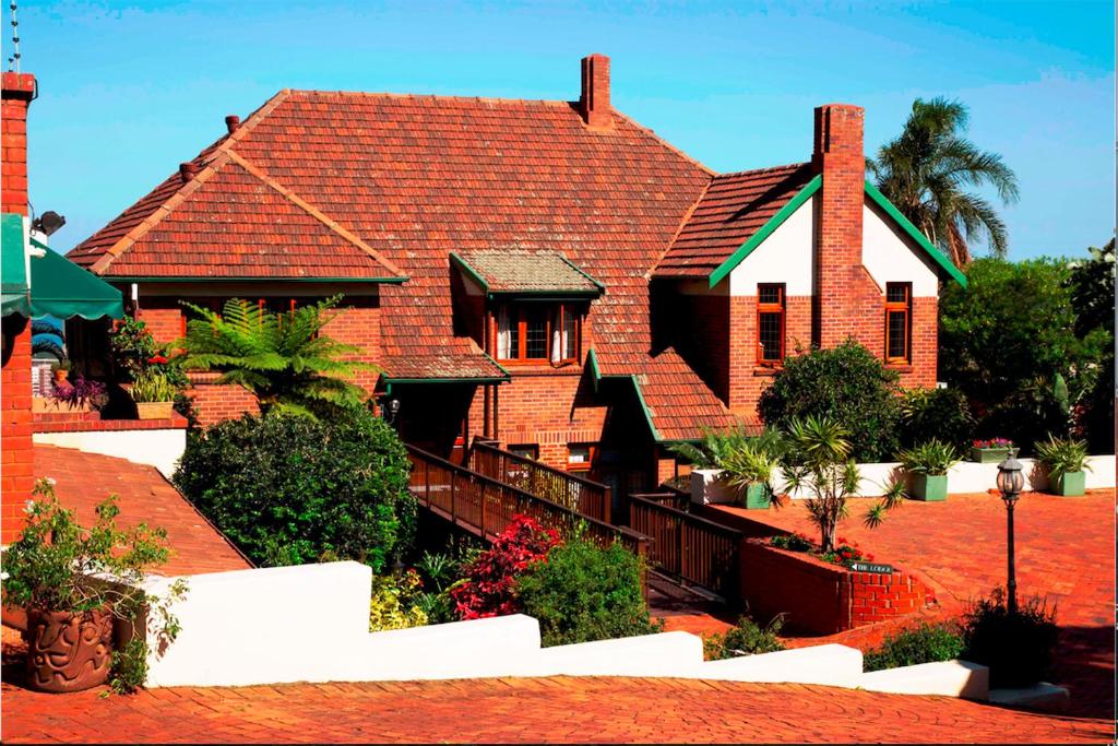 a red brick house with a red roof at Ridgeview Lodge in Durban