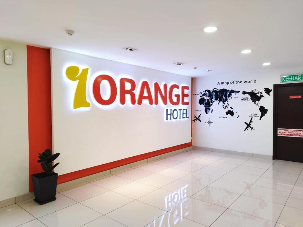 a z orange hotel room with a sign on a wall at 1 Orange Hotel Kuchai Lama KUALA LUMPUR in Kuala Lumpur