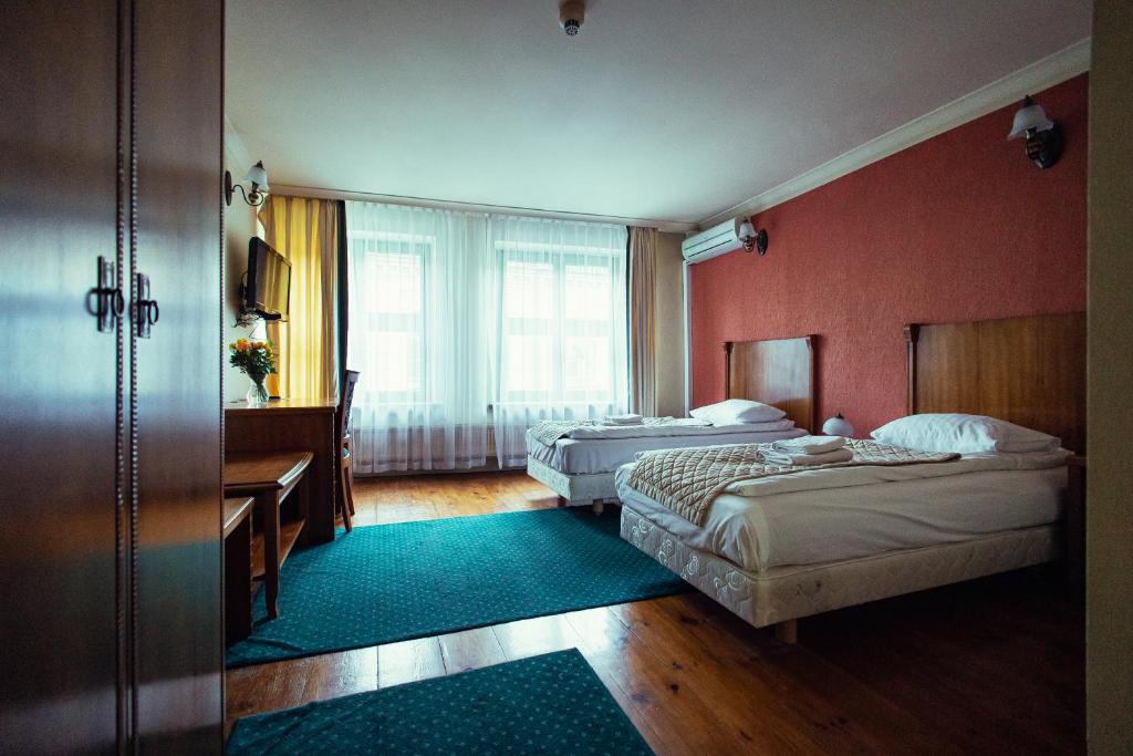 Postel nebo postele na pokoji v ubytování Heban Hotel