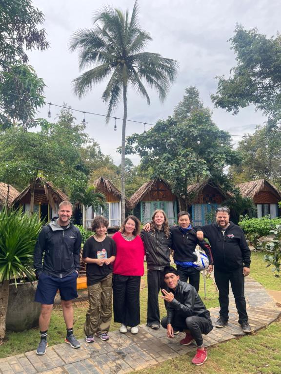 a group of people standing in front of a house at Garden Homestay in Di Linh
