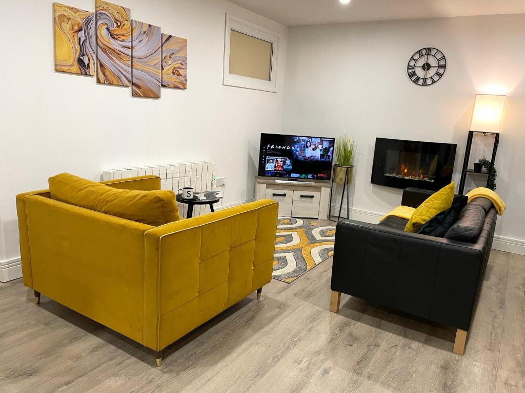 a living room with two couches and a tv at Luxurious New 2 Bed Apartment in Burnley, Lancashire in Burnley