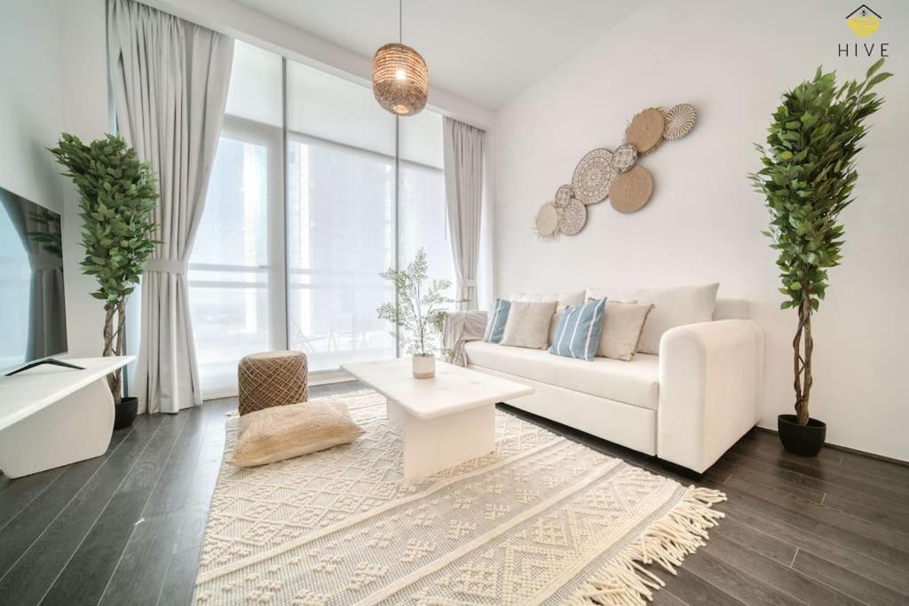 a living room with a white couch and a table at Beautiful 2 Bedroom Apartment in J8 in Dubai