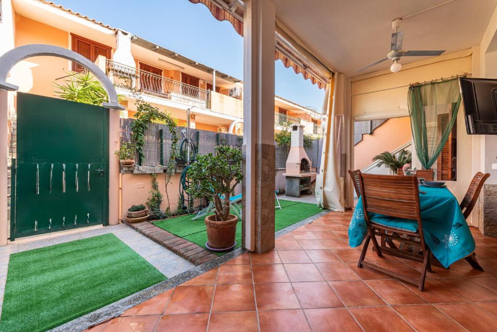 un balcón abierto con césped verde en una casa en Bellarosa 3 en Villasimius