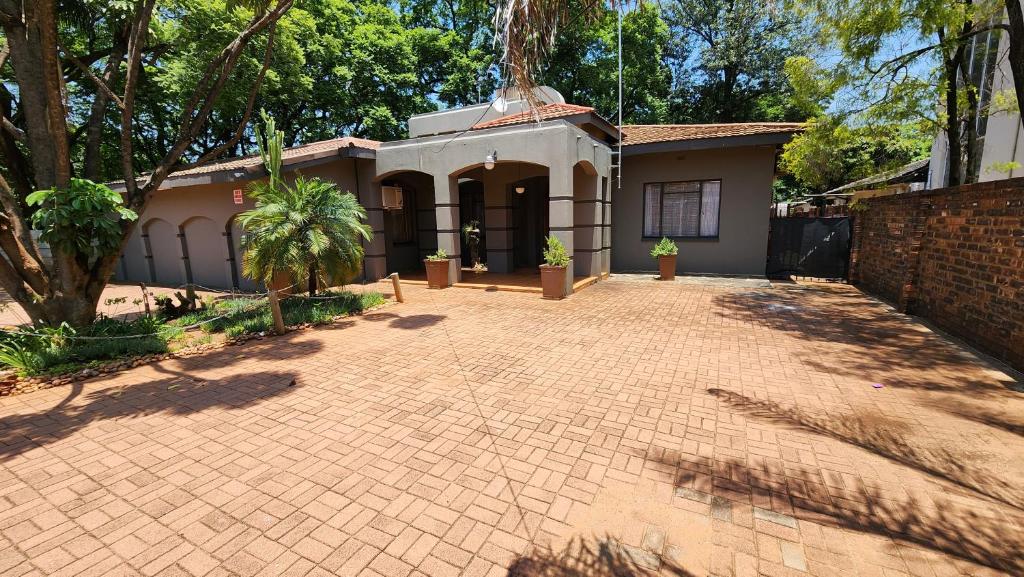 a house with a brick driveway in front of it at Casa Feliz in Mokopane