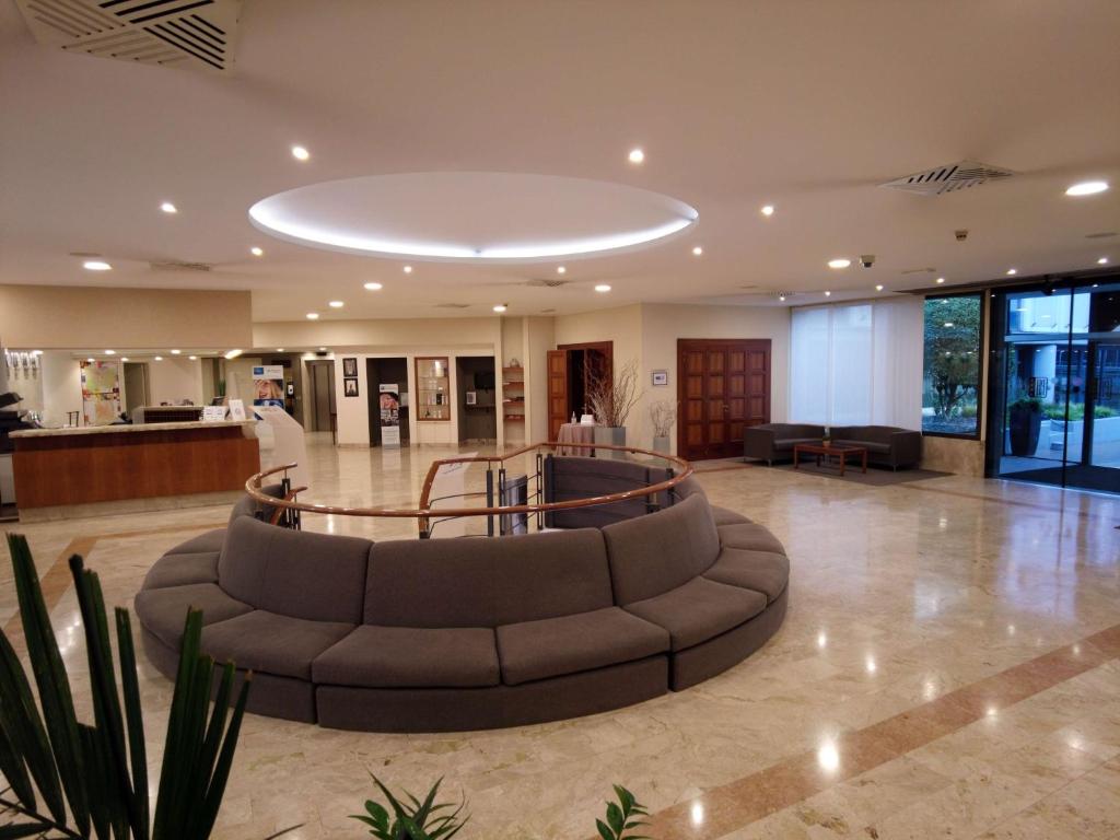 a large lobby with a couch in the middle at Best Western Park Hotel in Piacenza