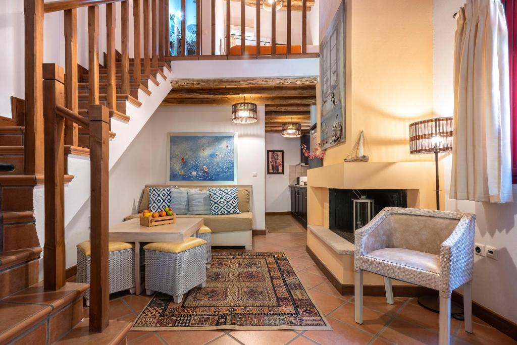 a living room with a staircase and a fireplace at The Varos Residences Hotel in Város