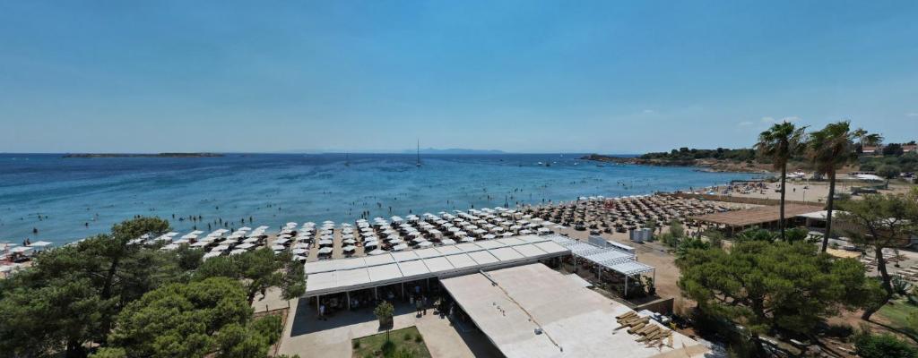 an aerial view of a beach with chairs and the ocean at Parthenis Riviera Hotel in Athens