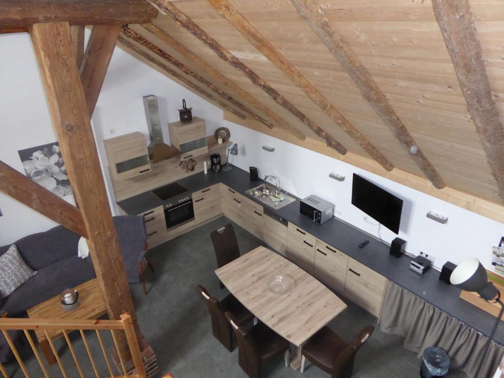 an overhead view of a room with a table and a television at Ferienwohnung Gulf im Gulfhof am Kanal in Großefehn 