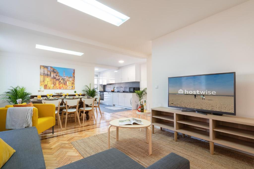 a living room with a large flat screen tv at Host Wise - Spacious Fresh Flat w Terrace - Near Sea in Espinho