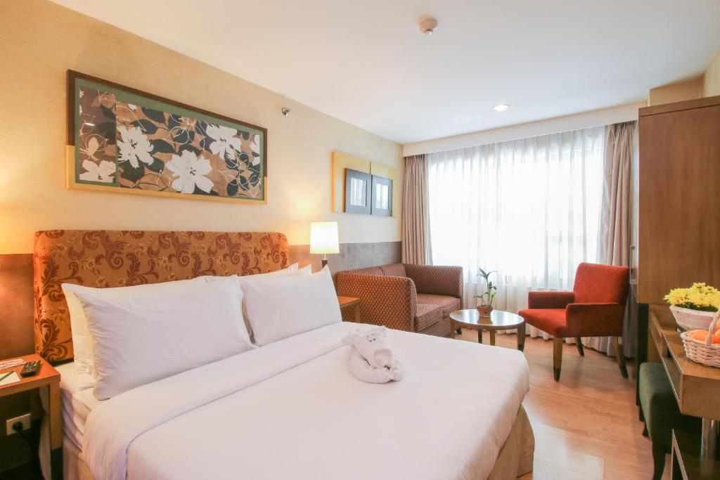 Postel nebo postele na pokoji v ubytování One Tagaytay Place Hotel Suites OFFICIAL ACCOUNT
